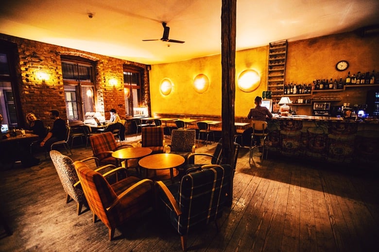 Interior of No Ku cafe showing cozy seating area with exposed brick walls